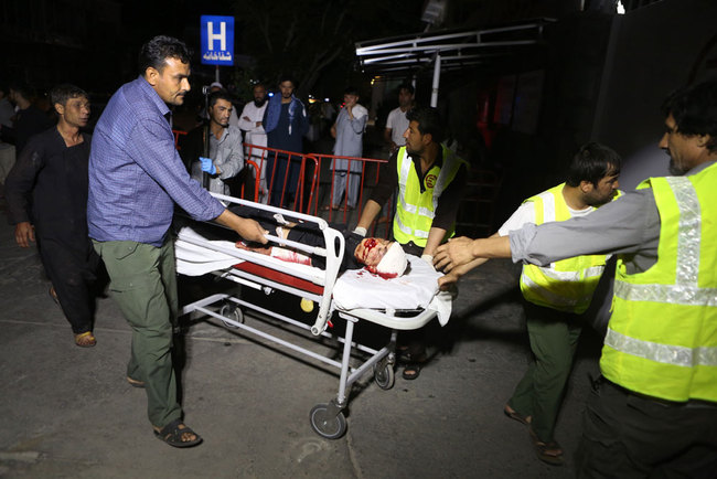 Afghan health workers carry a wounded child into the hospital after a suicide attacker exploded his explosive vest among a wedding ceremony in a wedding hall in Kabul, Afghanistan, August 18, 2019. [Photo: EPA via IC/Jawad Jalali]