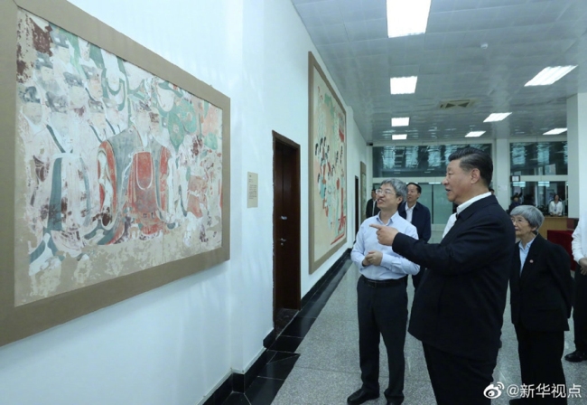 Chinese President Xi Jinping visited exhibitions of relics and research results and attended a symposium with experts, scholars and representatives from cultural units in the Dunhuang Academy in Dunhuang during his inspection tour of northwest China's Gansu Province, Aug. 19, 2019. [Photo: Xinhua/Ju Peng]
