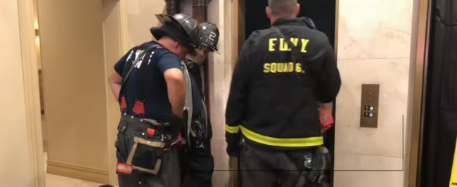 Police and building inspectors in New York city investigate the tragedy scene where a man was killed after being pinned between the elevator car and the shaft on Thursday, August 22, 2019. [Screenshot: China Plus]