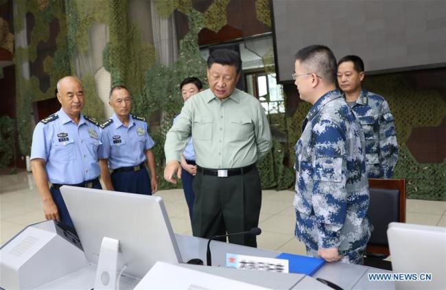 Chinese President Xi Jinping, also general secretary of the Communist Party of China Central Committee and chairman of the Central Military Commission, talks with military officials when inspecting an air force base in Gansu Province on August 22, 2019. [Photo: Xinhua/Li Gang]