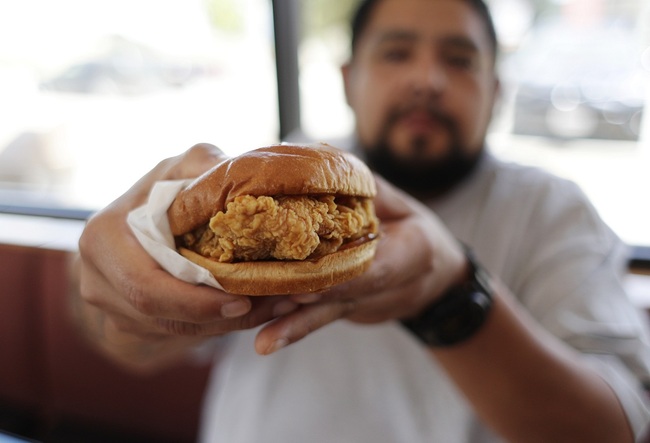 Randy Estrada holds up his chicken sandwiches at a Popeyes, Thursday, Aug. 22, 2019, in Kyle, Texas. [Photo: AP/Eric Gay]