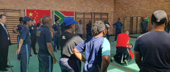 Two trainers from Fujian Police College demonstrates combat techniques to officers from the Johannesburg Metro Police Department. [Photo: Joburg Public Safety]