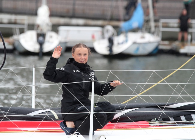 Greta Thunberg, a 16-year-old Swedish climate activist, waves after sailing in New York harbor aboard the Malizia II, Wednesday, Aug. 28, 2019. [Photo: AP]