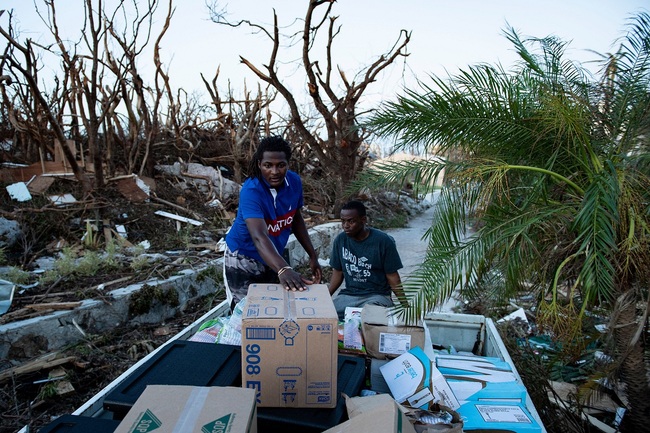 Volunteers with World Central Kitchen transport food relief for survivors of Hurricane Dorian September 5, 2019, in Marsh Harbor, Great Abaco, Bahamas. [Photo: AFP/Brendan Smialowski]