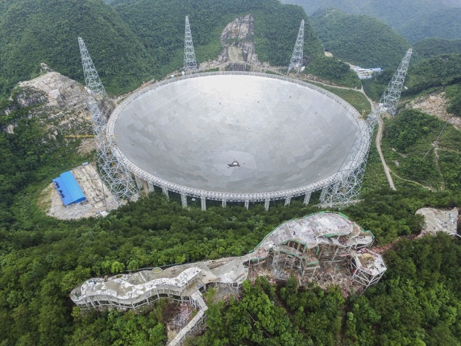 Aerial view of the construction site of the world's largest radio telescope called FAST (Five-hundred-meter Aperture Spherical Telescope) in Pingtang county, Qiannan Buyi and Miao Autonomous Prefecture, southwest China's Guizhou province, June 13, 2016. [File Photo: IC]