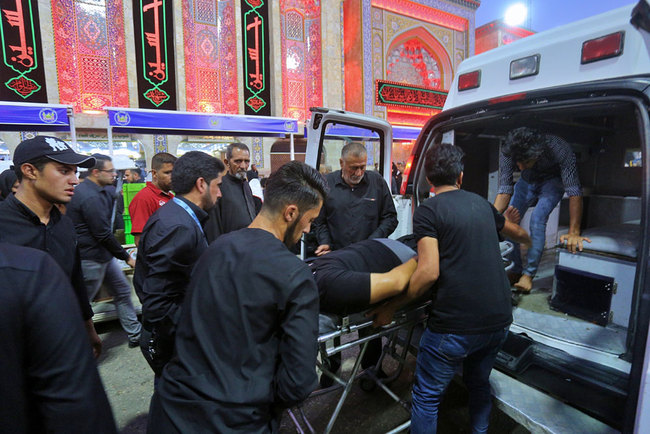 People evacuate an injured man after a walkway collapsed and set off a stampede as thousands of Shiite Muslims marked one of the most solemn holy days of the year in the holy city of Karbala, Iraq, Tuesday, Sept. 10, 2019. [Photo: AP via IC/Anmar Khalil]