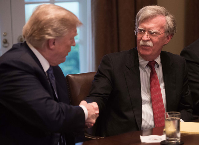 In this file photo taken on April 9, 2018, US President Donald Trump shakes hands with National Security Advisor John Bolton during a meeting with senior military leaders at the White House in Washington, DC. [File photo: AFP/Nicholas Kamm]