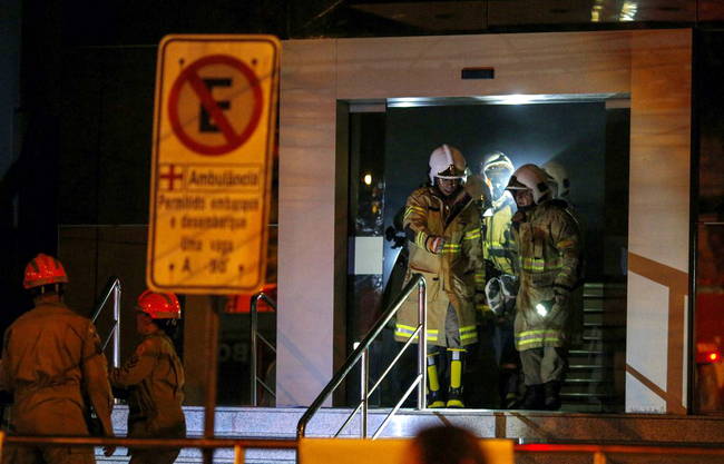 Firefighters transfer a patient during a fire at the Badim private Hospital in Tijuca neighborhood, Rio de Janeiro, Brazil, on September 12, 2019. [Photo: AFP/Mauro Pimentel]