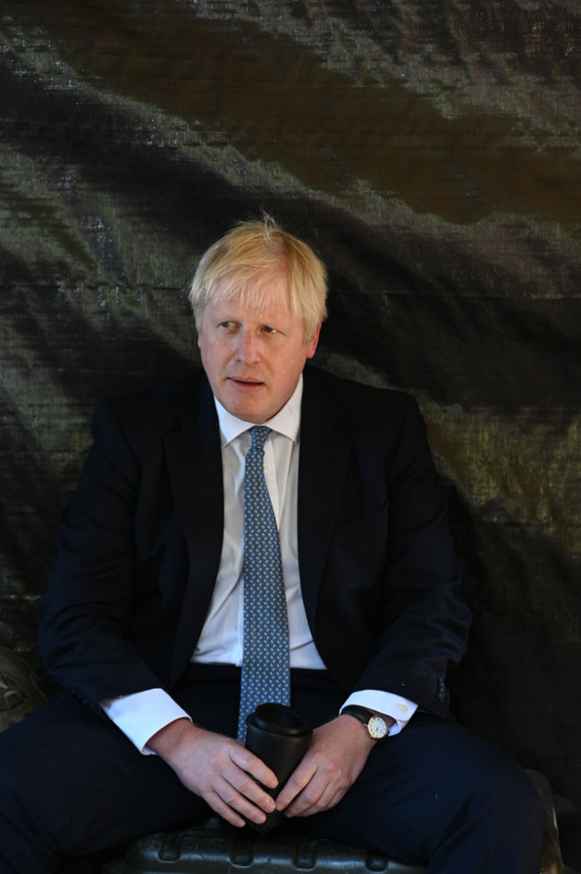 Britain's Prime Minister Boris Johnson meets with military personnel in a hut on Salisbury plain training area near Salisbury, southwest England on September 19, 2019. [Photo: AFP/Pool/Ben Stansall]