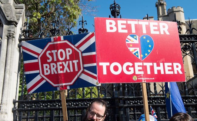 Anti-Brexit supporters from Stand of Defiance European Movement hold up placards outside Parliament at Parliament Square, London, UK on September 12, 2019. [Photo: IC]