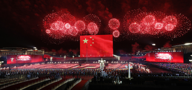 Fireworks sprout from the eastern and western ends of Tian'anmen Square and converge in the night sky in Beijing on Tuesday, October 1, 2019. Tian'anmen Square hosted a grand evening gala to celebrate the 70th anniversary of the founding of the People's Republic of China. [Photo: VCG]