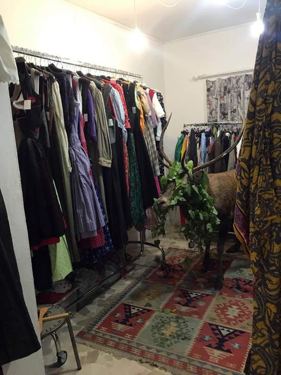 A deer stands by clothes after crashing into a shop in Cortina D'Ampezzo, Italy, Tuesday, Oct. 1, 2019. A dazed and confused deer has been trapped in a clothing store in the fashionable mountain resort of Cortina d'Ampezzo, on the Italian Dolomites, before been saved and freed. Local authorities said the deer, a four-five years-old big specimen, entered the shop, specialized in tirolese outfits, by mistake as the assistant was away. Authorities said It was necessary to isolate the whole Cortina's square to allow vets to catch the deer, anesthetize it and then bring him back into the wild. [Photo: AP/Ufficio Stampa Provincia di Belluno]