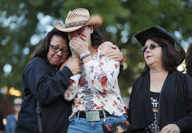 Yvonne Justice, left, comforts Emily Sebring during a ceremony Tuesday, Oct. 1, 2019, on the anniversary of the mass shooting two years earlier, in Las Vegas. [Photo: AP]