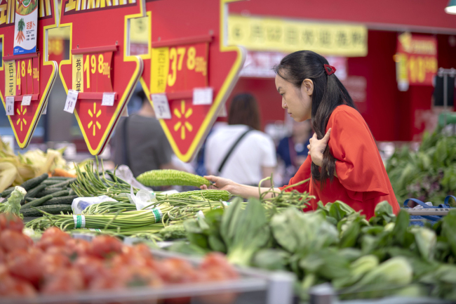 A consumer buying vegetable in a supermarket in Guangzhou on September 12, 2019. [File Photo: VCG]