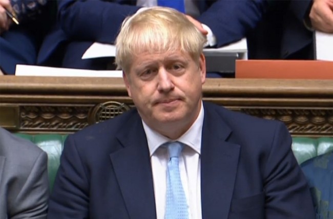 A video grab from footage shows Britain's Prime Minister Boris Johnson listens to the questions of Labour leader Jeremy Corbyn on October 3, 2019. [Photo: HO / AFP / PRU]