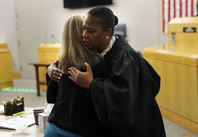 State District Judge Tammy Kemp gives former Dallas Police Officer Amber Guyger a hug before Guyger leaves for jail, Wednesday, Oct. 2, 2019, in Dallas. [Photo: AP]