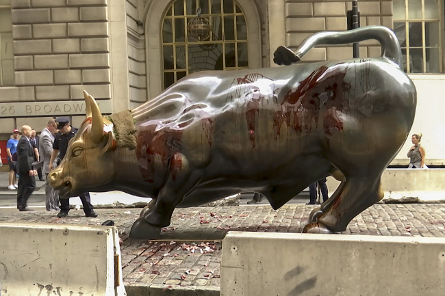 In this freeze frame made from a video stage blood covers the iconic "Charging Bull" statue near Wall Street on Monday Oct. 7, 2019, in New York. [Photo: AP/Ted Shaffrey]