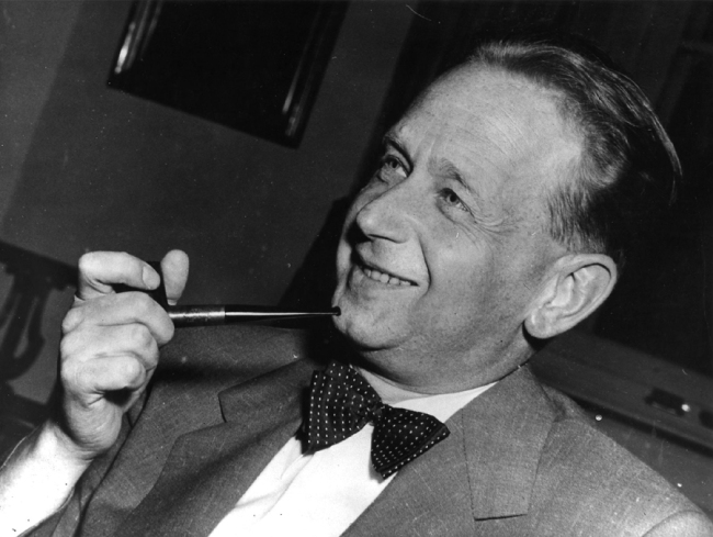 In this May 19, 1953, file ., Dag Hammarskjold, recently appointed secretary general of the United Nations who is on a visit to Sweden, smokes his pipe at a press conference held at the Foreign Office in Stockholm. [Photo: IC]