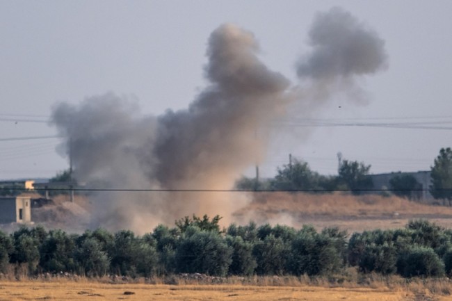 Smoke rises from the Syrian town of Tal Abyad after Turkish bombings, in a picture taken from the Turkish side of the border near Akcakale in the Sanliurfa province on October 9, 2019. [Photo: AFP/Bulent Kilic]