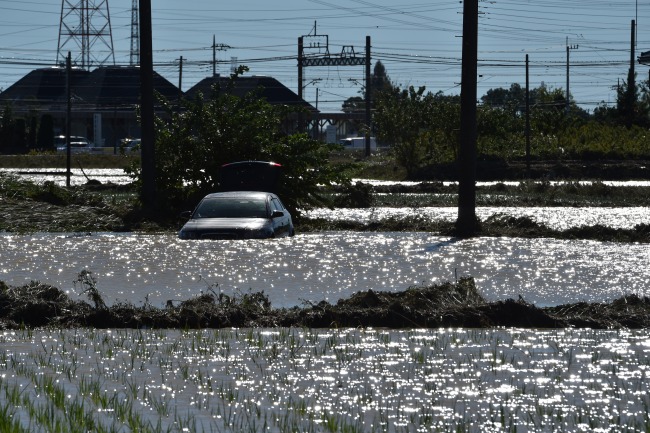 A car sits in a flooded field in Higashi-matsuyama, Saitama prefecture on October 13, 2019, after Typhoon Hagibis swept through central and eastern Japan. [Photo: AFP/ Kazuhiro NOGI]