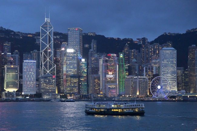 A ferry passes in front of the Central district on the Victoria Harbor in Hong Kong. [File Photo: IC]