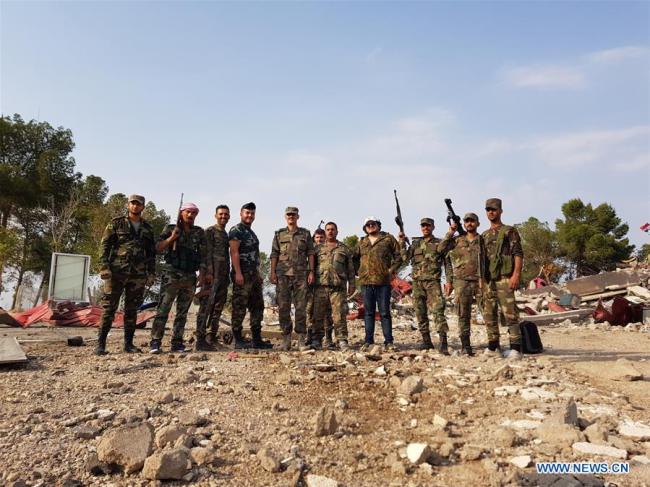 Syrian soldiers pose for a photo in a destroyed U.S.-run military base in the village of Qasr Yalda in the western countryside of Hasakah province, northeastern Syria, Oct. 19, 2019. [Photo: Xinhua]