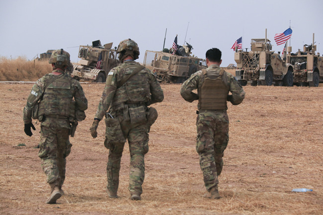 American military convoy stops near the town of Tel Tamr, north Syria, Sunday, Oct. 20, 2019. Kurdish-led fighters and Turkish-backed forces clashed sporadically Sunday in northeastern Syria amid efforts to work out a Kurdish evacuation from a besieged border town, the first pull-back under the terms of a U.S.-brokered cease-fire. [Photo: AP/Baderkhan Ahmad]