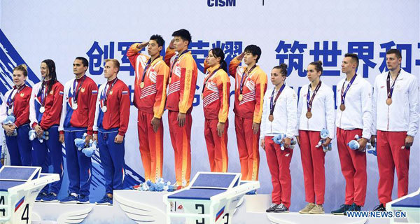 Gold medalist team China, silver medalist team Russia and bronze medalist team Poland attend the awarding ceremony of mixed 4×100m freestyle relay final of swimming at the 7th CISM Military World Games in Wuhan, capital of central China's Hubei Province, October 21, 2019. [Photo: Xinhua/Cheng Min]