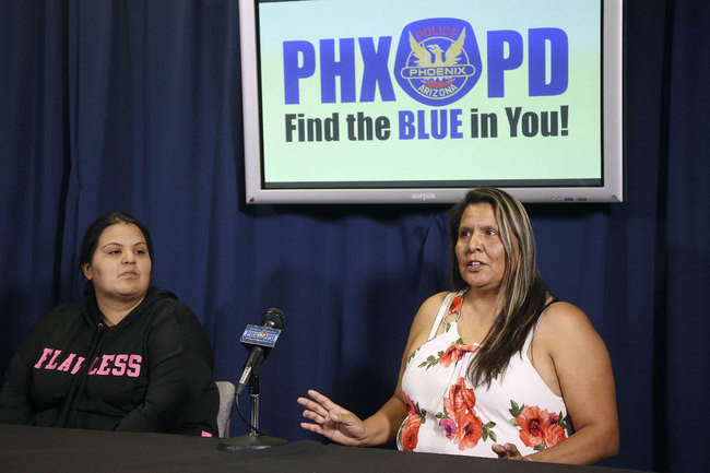 Shannon Vivar, left, listens to her mother Shirley Vivar, right, speak as the two talk about being in their vehicle as they were hit by a red light runner, during a news conference at Phoenix Police headquarters Thursday, Oct. 24, 2019, in Phoenix. [Photo: AP]