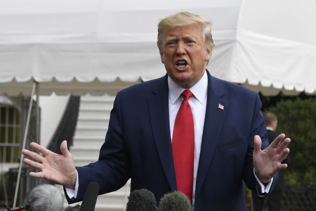 President Donald Trump talks to reporters on the South Lawn of the White House in Washington, Friday, Oct. 25, 2019, before boarding Marine One for the short trip to Andrews Air Force Base. [Photo: AP]