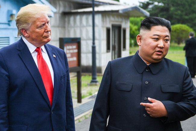North Korea's leader Kim Jong Un speaks as he stands with US President Donald Trump south of the Military Demarcation Line that divides North and South Korea, in the Joint Security Area (JSA) of Panmunjom in the Demilitarized zone (DMZ) on June 30, 2019. [File photo: AFP/Brendan Smialowski]