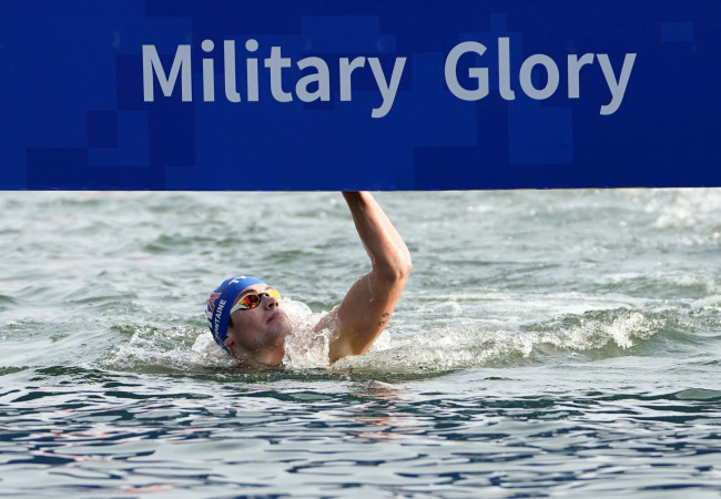Logan Fontaine of France touches home in the mixed team finals of the open-water swimming competition at the 7th Military World Games in Wuhan on Saturday, October 27, 2019. [Photo provided to China Plus]