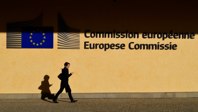A woman walks by the European Commission headquarters in Brussels, on October 28, 2019. [Photo: AFP/JOHN THYS]