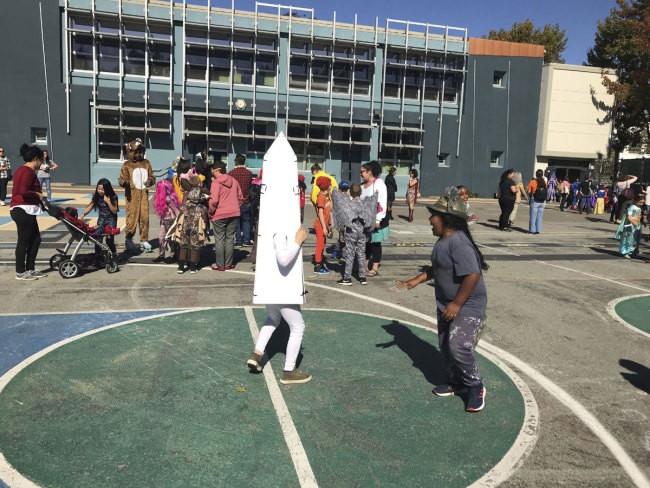 Children at Washington Elementary in Berkeley, Calif., play during the school's annual Halloween costume parade outside on Thursday, Oct. 31, 2019. [Photo: AP]