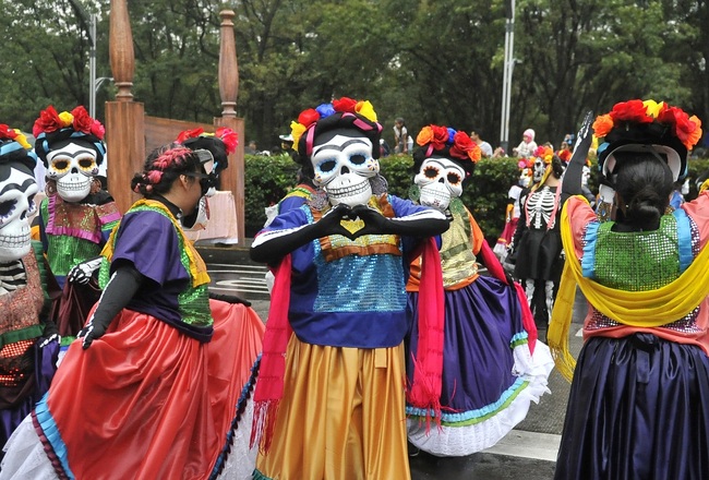 People take part in the Day of the Dead parade along Reforma avenue in Mexico City, on October 27, 2019. [Photo: AFP/CLAUDIO CRUZ ]