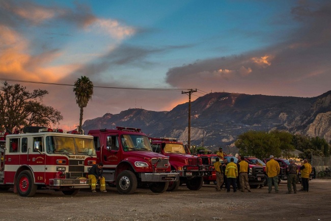 Firefighters are taking a break at the end of the day in front of the scorched mountain, after the Maria Fire, in Santa Paula, Ventura County, California on November 02, 2019. [Photo: VCG]