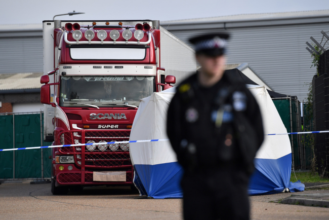 In this photo taken on October 23, 2019, a police officer secures the cordon at the scene where a lorry, found to be containing 39 dead bodies, was discovered at Waterglade Industrial Park in Grays, east of London. [Photo: AFP/Ben Stansall]