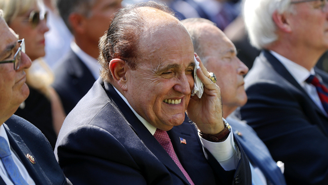 Rudy Giuliani, an attorney for U.S. President Donald Trump, wipes his forehead as he listens to President Donald Trump speak before Trump signed H.R. 1327, an act ensuring that a victims' compensation fund related to the Sept. 11 attacks never runs out of money, in the Rose Garden of the White House, July 29, 2019, in Washington. [Photo: AP/Pablo Martinez Monsivais]