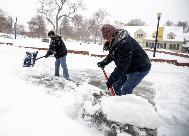 University of Northern Colorado facilities management staff shovel snow from the steps and entranceway to Sabin Hall during a winter storm in Greeley, Colo., November 26, 2019. [Photo: AP]