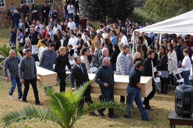 In this Nov. 7, 2019 file photo, men carry the remains of Dawna Ray Langford, 43, and her sons Trevor, 11, and Rogan, 2, who were killed by drug cartel gunmen, before they are buried at a family cemetery in La Mora, Sonora state, Mexico. [File photo: AP]