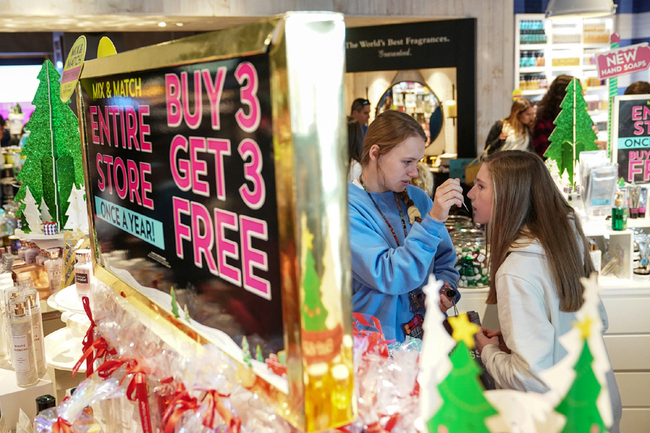 Girls smell products in Bath and Body Works in King of Prussia mall, one of the largest retail malls in the U.S., on Black Friday, a day that kicks off the holiday shopping season, in King of Prussia, Pennsylvania, U.S., November 29, 2019. [Photo: VCG]