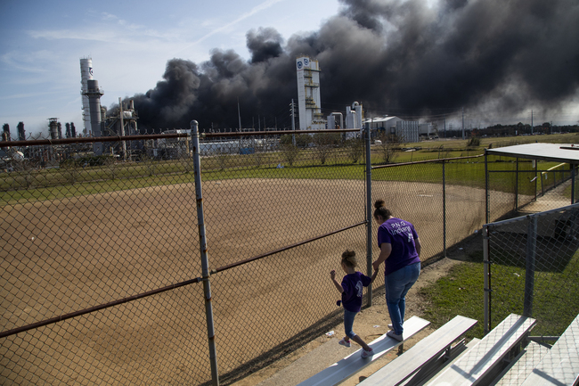 Cloud of smoke in the background from the TPC Group Port Neches Operations explosion is visible from a little league baseball park on Wednesday, Nov. 27, 2019, in Port Neches, Texas. [Photo: AP]