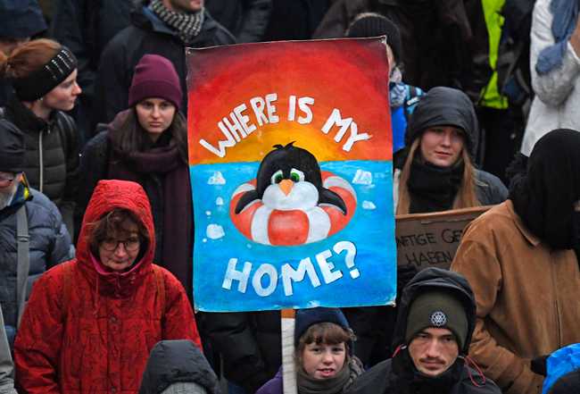 A demonstrator holds a poster during a protest climate strike ralley of the 'Friday For Future Movement' in Leipzig, Germany, Friday, Nov. 29, 2019. Cities all over the world have strikes and demonstrations for the climate during this ClimateActionDay. [Photo:AP/Jens Meyer]