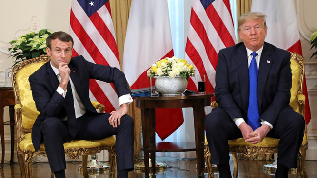 US President Donald Trump (R) and France's President Emmanuel Macron react as they talk during their meeting at Winfield House, London on December 3, 2019. [Photo: AFP/Ludovic Marin]