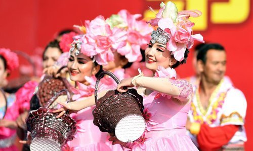 Actresses perform during a jujube harvest festival in Qiemo County, northwest China's Xinjiang Uygur Autonomous Region, Oct. 19, 2019. Qiemo County, situated in the Mongolian Autonomous Prefecture of Bayingolin and on the edge of the Tarim Basin, is known for high-quality jujube production.   [Photo: Xinhua/Sadat]