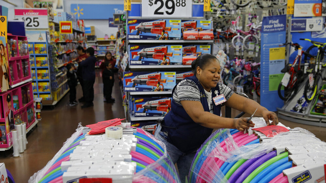 In this Nov. 27, 2019, file photo Balo Balogun labels items in preparation for a holiday sale at a Walmart Supercenter in Las Vegas. On Friday, Dec. 6, the U.S. government issues the November jobs report. [File Photo: AP/John Locher]