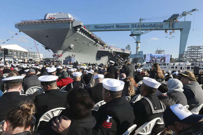 Spectators take their seats as they wait for ceremonies to begin for the christening of the nuclear aircraft carrier John F. Kennedy at Newport News Shipbuilding in Newport News, Va., Saturday, Dec. 7, 2019. [Photo: AP]