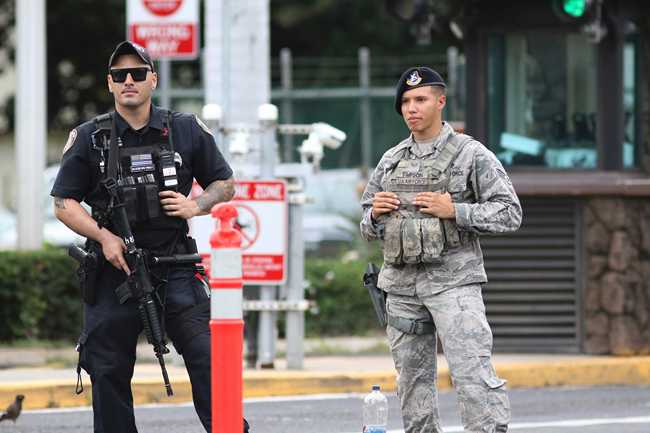 Security stands guard outside the main gate at Joint Base Pearl Harbor-Hickam, in Hawaii, Wednesday, Dec. 4, 2019. [Photo: AP]