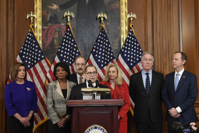 From left House Speaker Nancy Pelosi, Chairwoman of the House Financial Services Committee Maxine Waters, D-Calif., Chairman of the House Foreign Affairs Committee Eliot Engel, D-N.Y., House Judiciary Committee Chairman Jerrold Nadler, D-N.Y., Chairwoman of the House Committee on Oversight and Reform Carolyn Maloney, D-N.Y., House Ways and Means Chairman Richard Neal and Chairman of the House Permanent Select Committee on Intelligence Adam Schiff, D-Calif., unveil articles of impeachment against President Donald Trump, during a news conference on Capitol Hill in Washington, Tuesday, Dec. 10, 2019. [Photo: AP/Susan Walsh]
