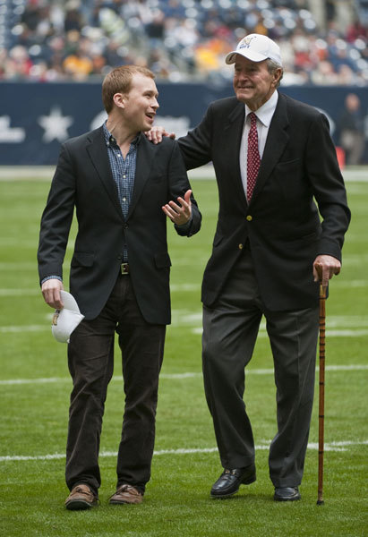 In this Thursday, Dec. 31, 2009 file photo, former United States President George H. W. Bush, right, leaves the field with the help of Pierce Bush, left, his grandson, before the Texas Bowl NCAA college football game in Houston. Pierce Bush announced Monday, Dec. 9, 2019 that he'll run in the Republican primary for a congressional seat near Houston. [Photo: AP/Dave Einsel]